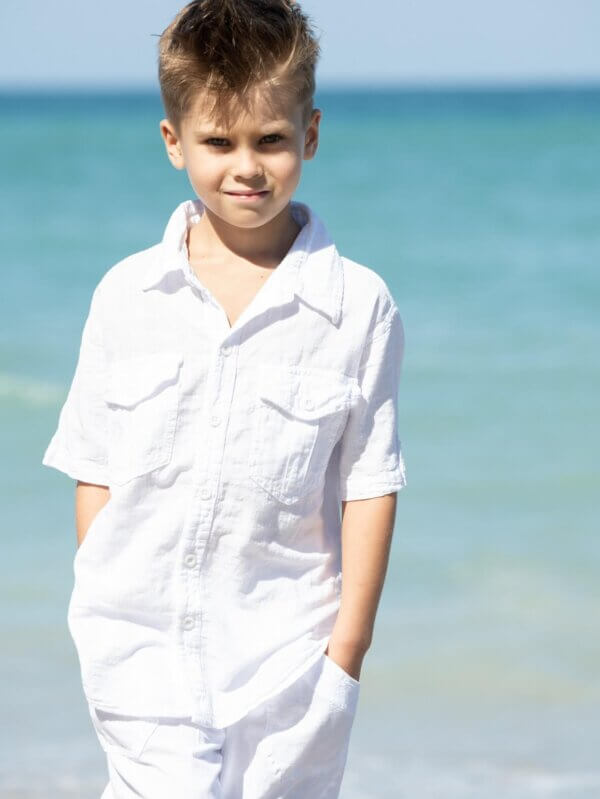 Boy on beach in white shirt