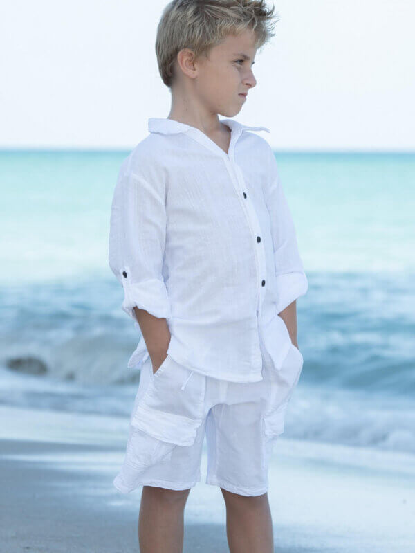 Boy on beach with white outfit