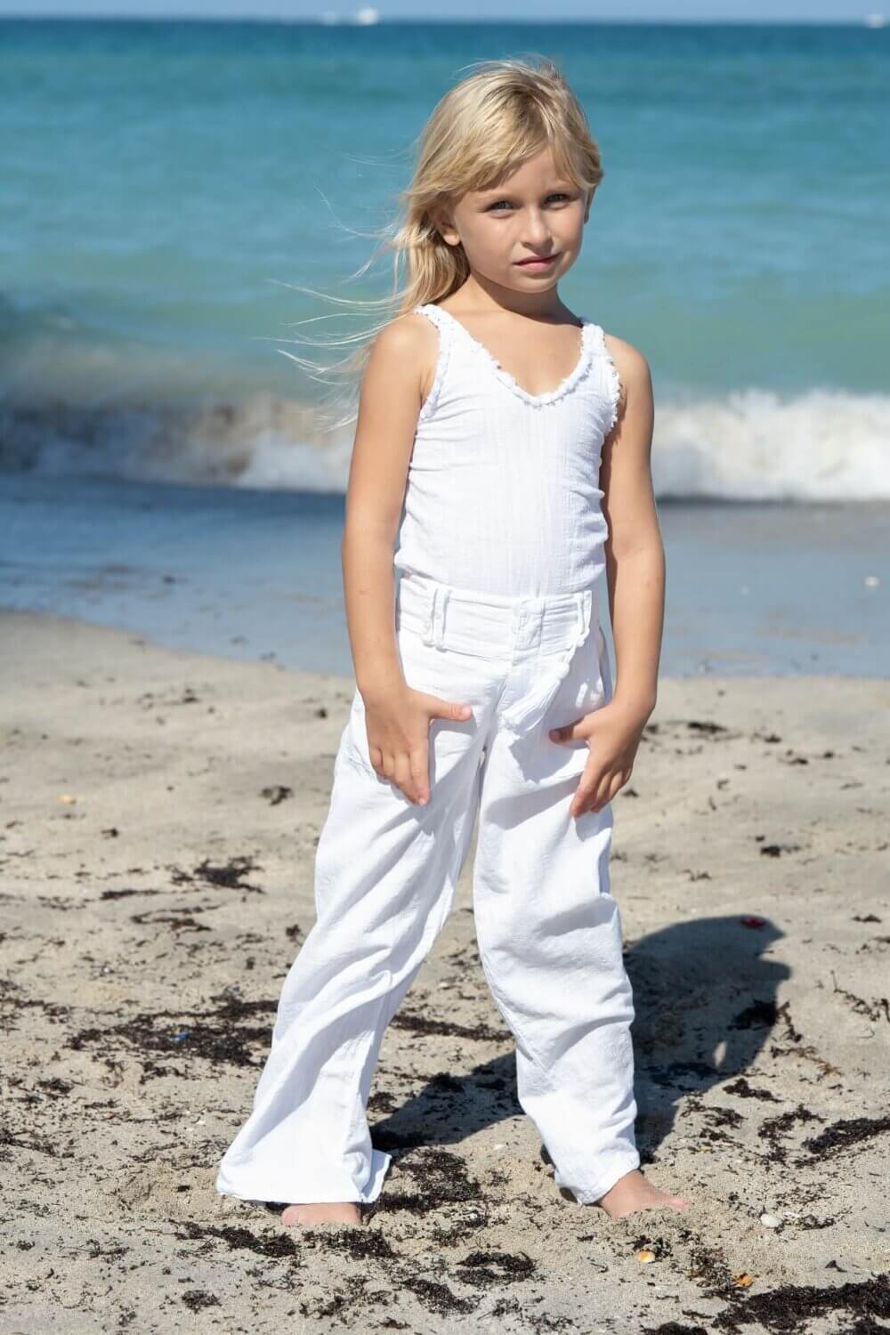 Girl on beach in white outfit