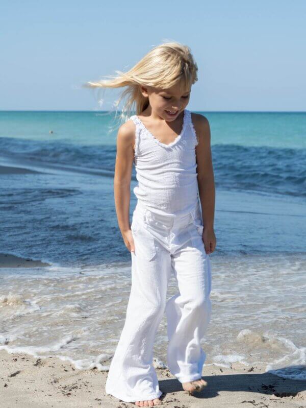 Girl on beach in white outfit