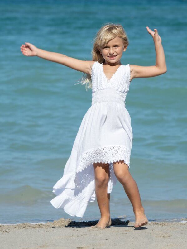 Girl in white dress on the beach