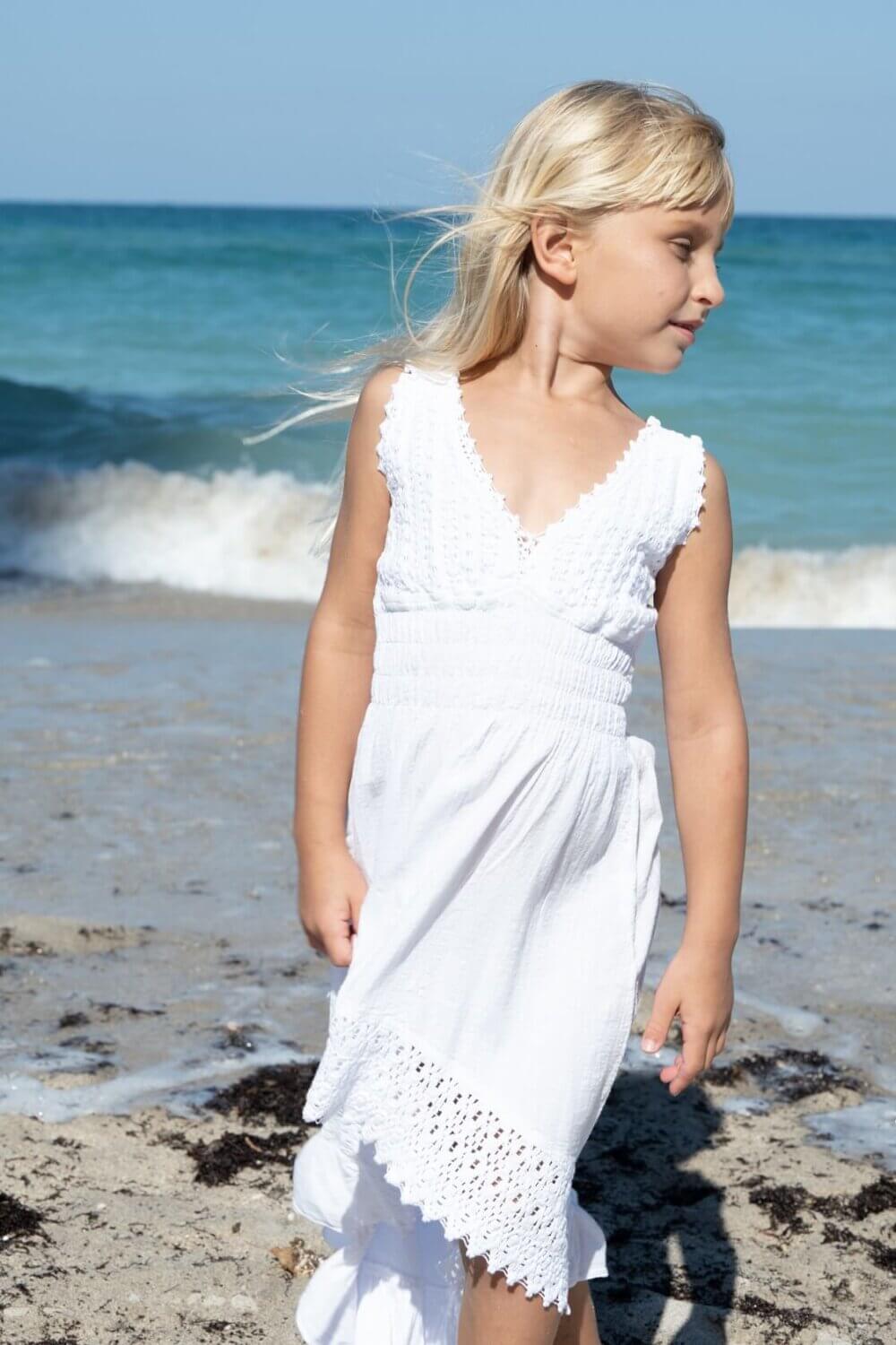 Girl in white dress on the beach